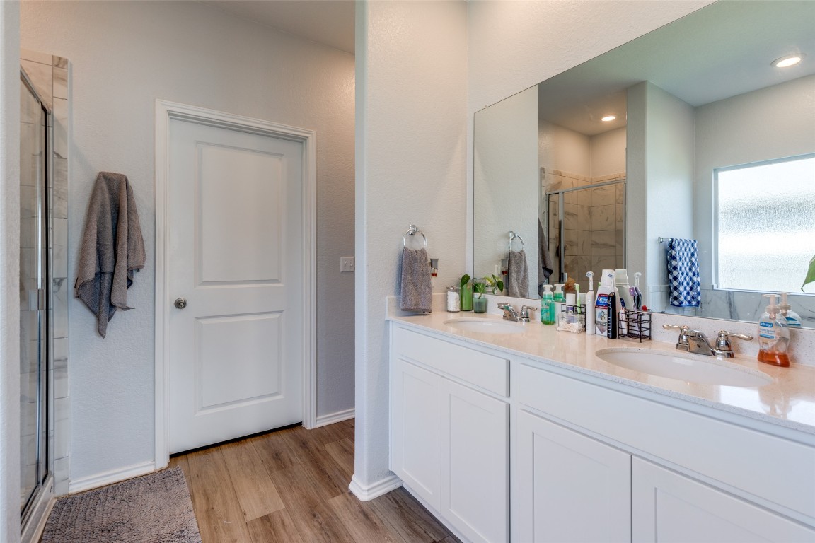 207 Otter Road Kyle, TX 78640 - Photo 14 of 26 a bathroom with a sink and mirror