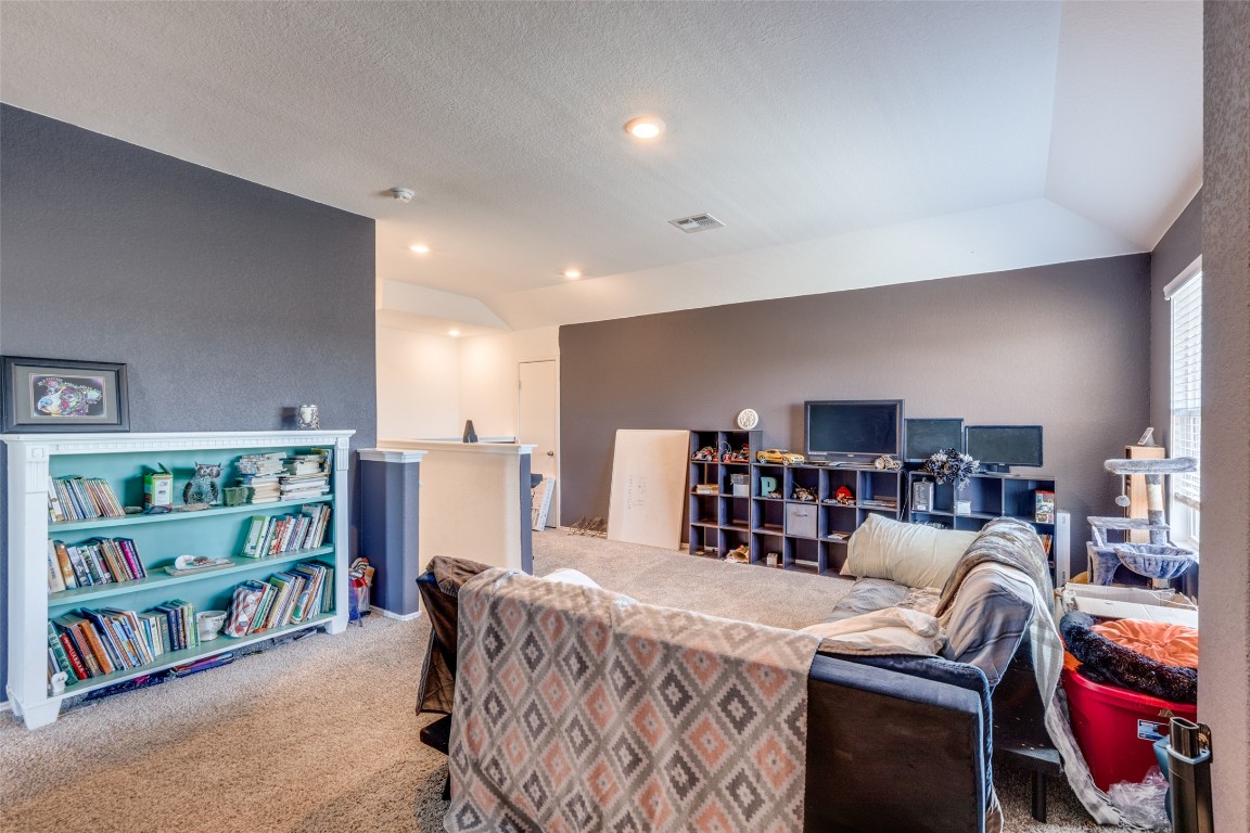 207 Otter Road Kyle, TX 78640 - Photo 17 of 26 a living room with furniture and a book shelf