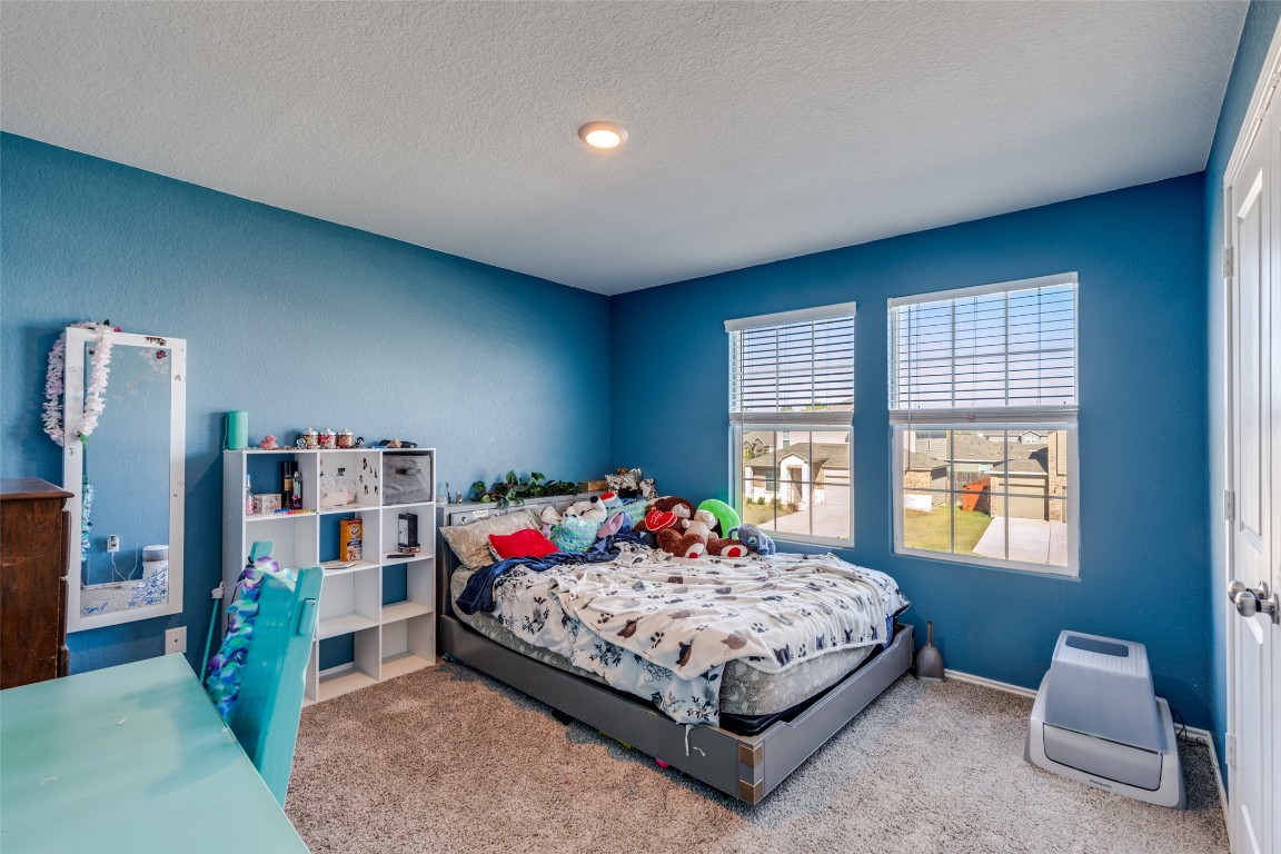 207 Otter Road Kyle, TX 78640 - Photo 19 of 26 a bedroom with a bed and a large window