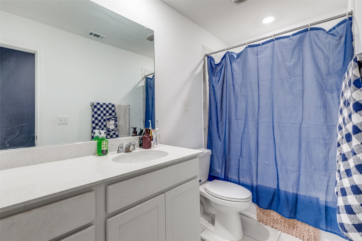 207 Otter Road Kyle, TX 78640 - Photo 20 of 26 a bathroom with a sink a toilet and shower