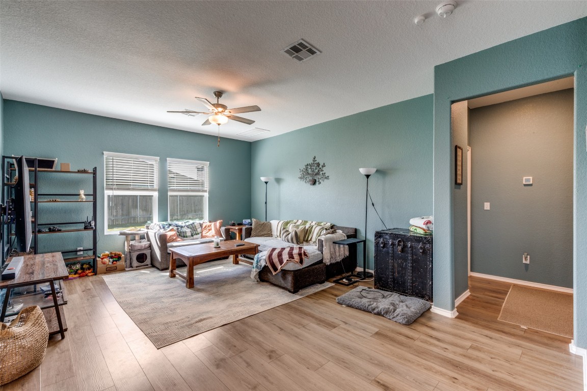 207 Otter Road Kyle, TX 78640 - Photo 4 of 26 a living room with furniture and wooden floor