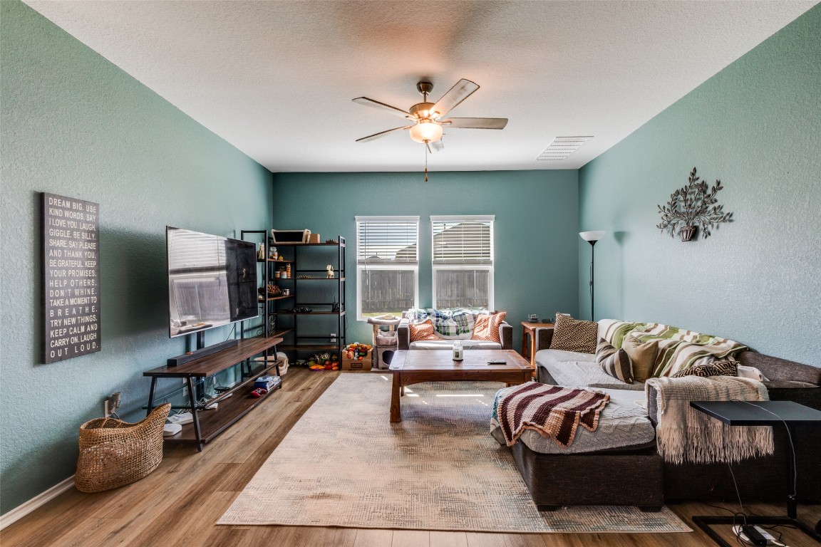 207 Otter Road Kyle, TX 78640 - Photo 5 of 26 a living room with furniture and a flat screen tv