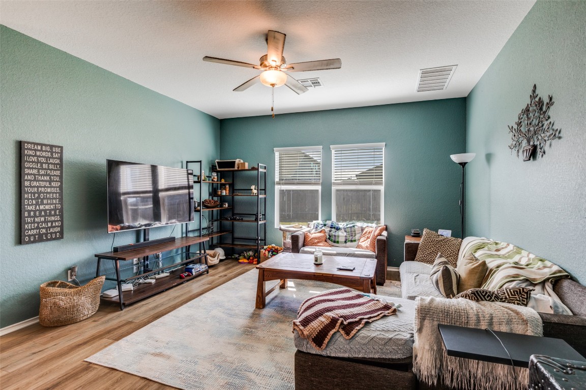 207 Otter Road Kyle, TX 78640 - Photo 6 of 26 a living room with furniture and a fireplace