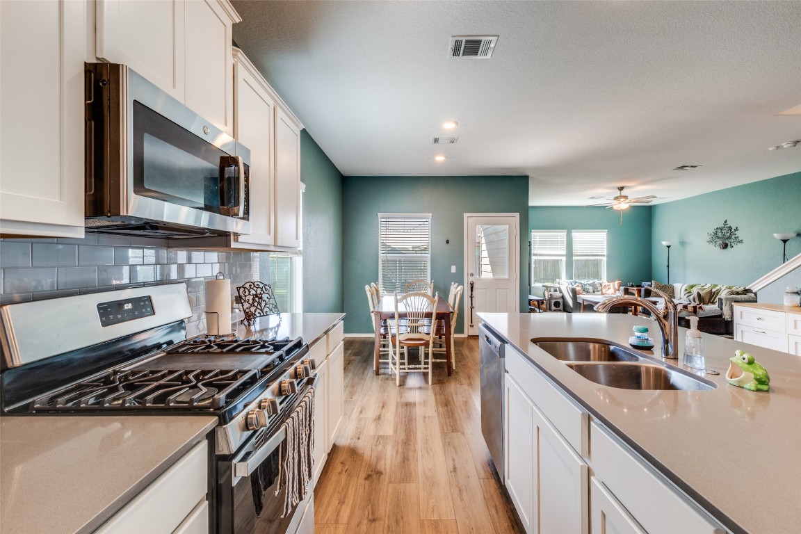 207 Otter Road Kyle, TX 78640 - Photo 7 of 26 a kitchen with lots of counter top space a sink and appliances