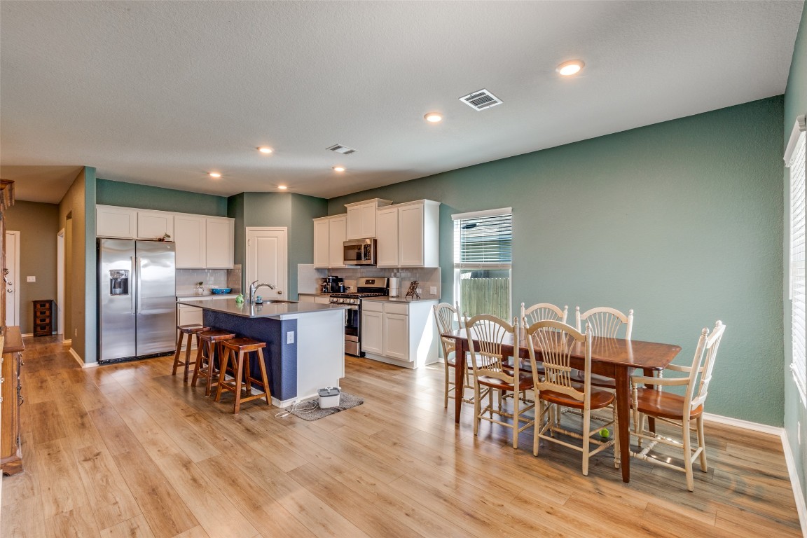 207 Otter Road Kyle, TX 78640 - Photo 9 of 26 a view of a dining room with furniture kitchen and chandelier
