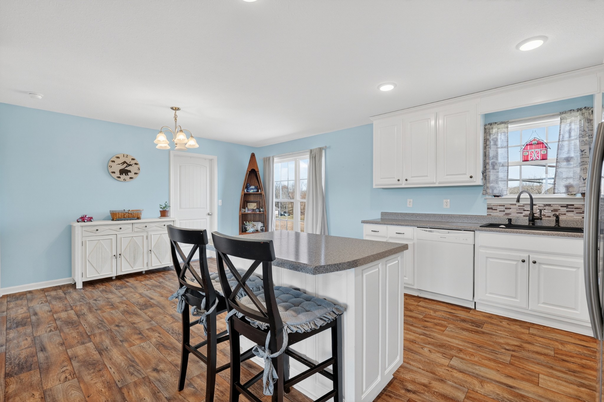 198 L Mitchell Road Flintville, TN 37335 - Photo 12 of 41 a kitchen with stainless steel appliances kitchen island granite countertop a dining table chairs and white cabinets
