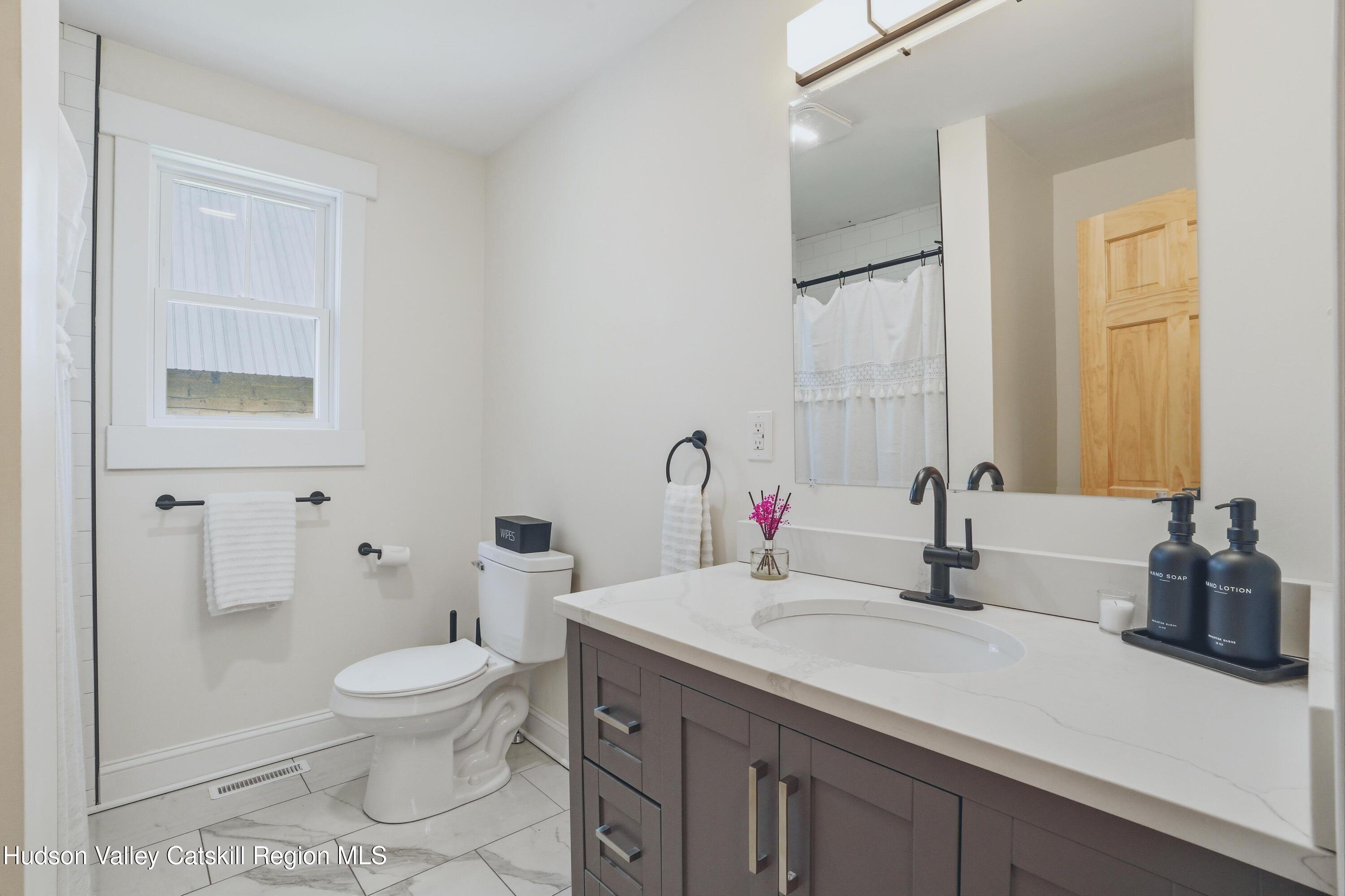 757 Taborton Road Sand Lake, NY 12153 - Photo 18 of 32 a bathroom with a sink toilet and shower