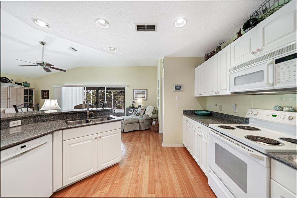 425 Islamorada Boulevard Punta Gorda, FL 33955 - Photo 11 of 44 a kitchen with granite countertop a sink a counter space appliances and cabinets