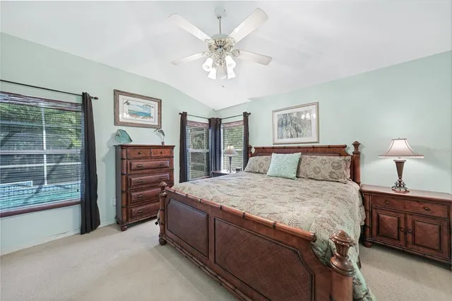 a bedroom with a bed and dresser with window