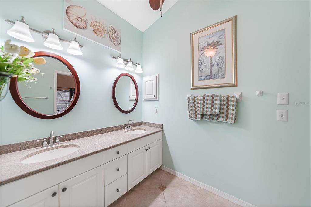 425 Islamorada Boulevard Punta Gorda, FL 33955 - Photo 17 of 44 a bathroom with a granite countertop double vanity sink and a mirror