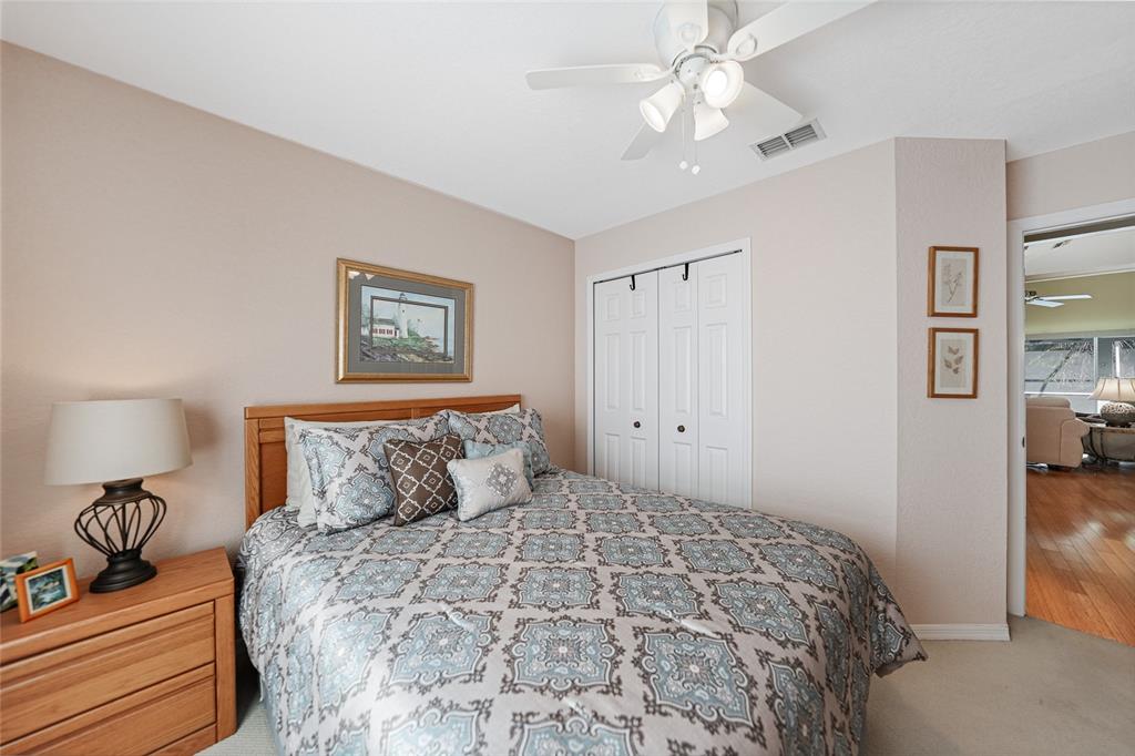 425 Islamorada Boulevard Punta Gorda, FL 33955 - Photo 19 of 44 a bedroom with a bed and a chandelier