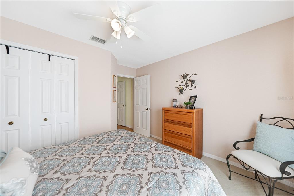425 Islamorada Boulevard Punta Gorda, FL 33955 - Photo 20 of 44 a bedroom with a bed and a chandelier