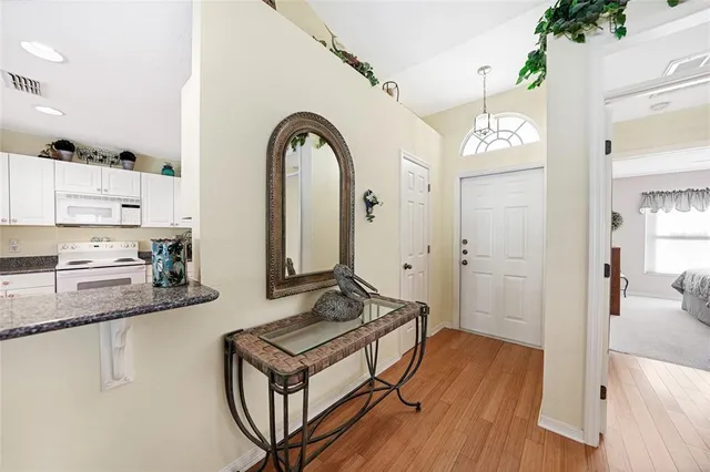 a kitchen with stainless steel appliances granite countertop a stove and a wooden floors
