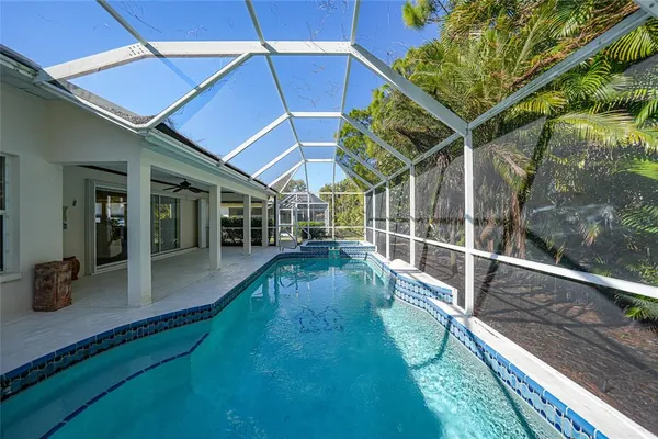 a view of a backyard with pool table and chairs