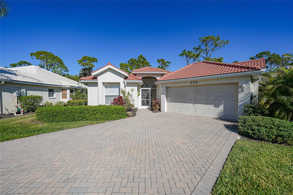 425 Islamorada Boulevard Punta Gorda, FL 33955 - Photo 30 of 44 a front view of a house with a garden