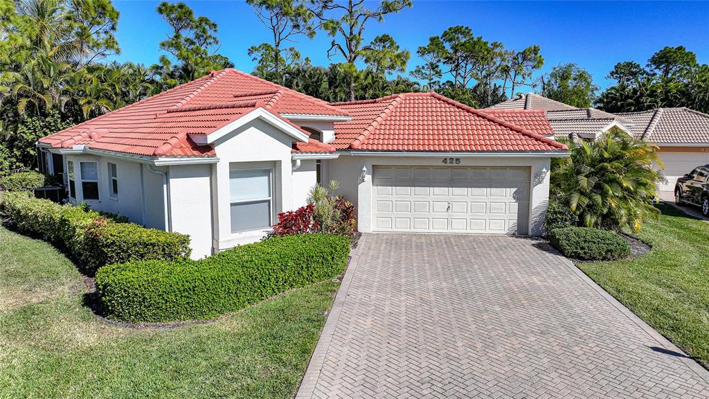 425 Islamorada Boulevard Punta Gorda, FL 33955 - Photo 31 of 44 a front view of a house with a garden and plants