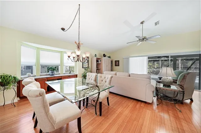 a living room with furniture a ceiling fan and a window