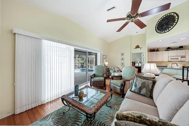 a living room with furniture a rug and a window