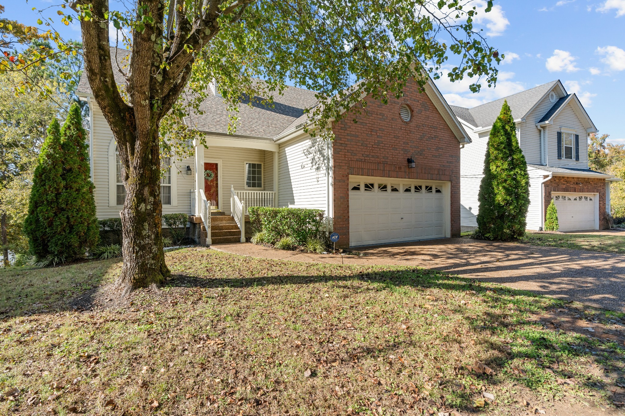 1068 Tulip Grove Road Hermitage, TN 37076 - Photo 15 of 100 a front view of a house with a yard and garage