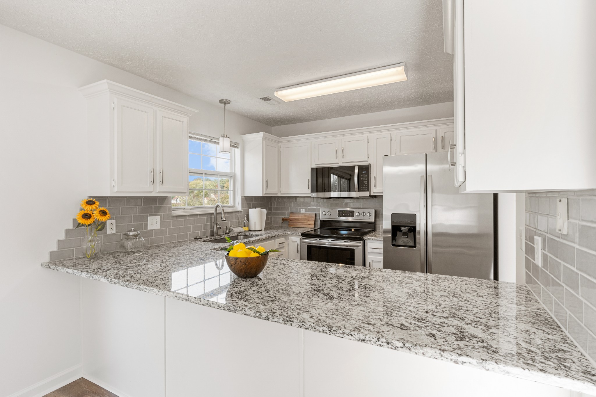 1068 Tulip Grove Road Hermitage, TN 37076 - Photo 38 of 100 a kitchen with stainless steel appliances granite countertop a sink stove and refrigerator