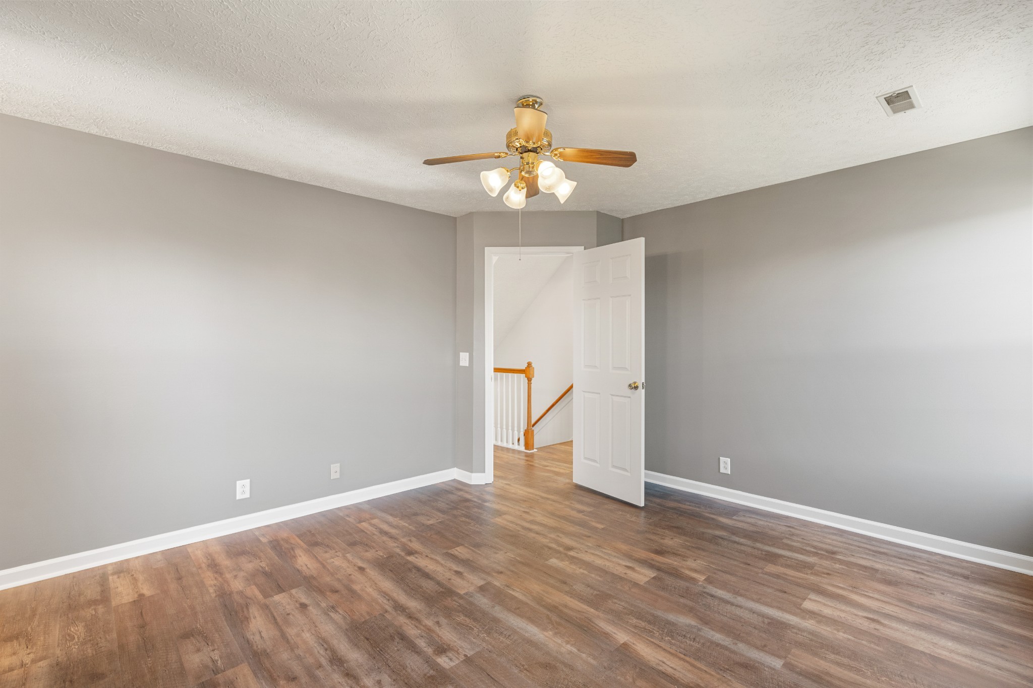 1068 Tulip Grove Road Hermitage, TN 37076 - Photo 58 of 100 a view of an empty room with chandelier fan and wooden floor