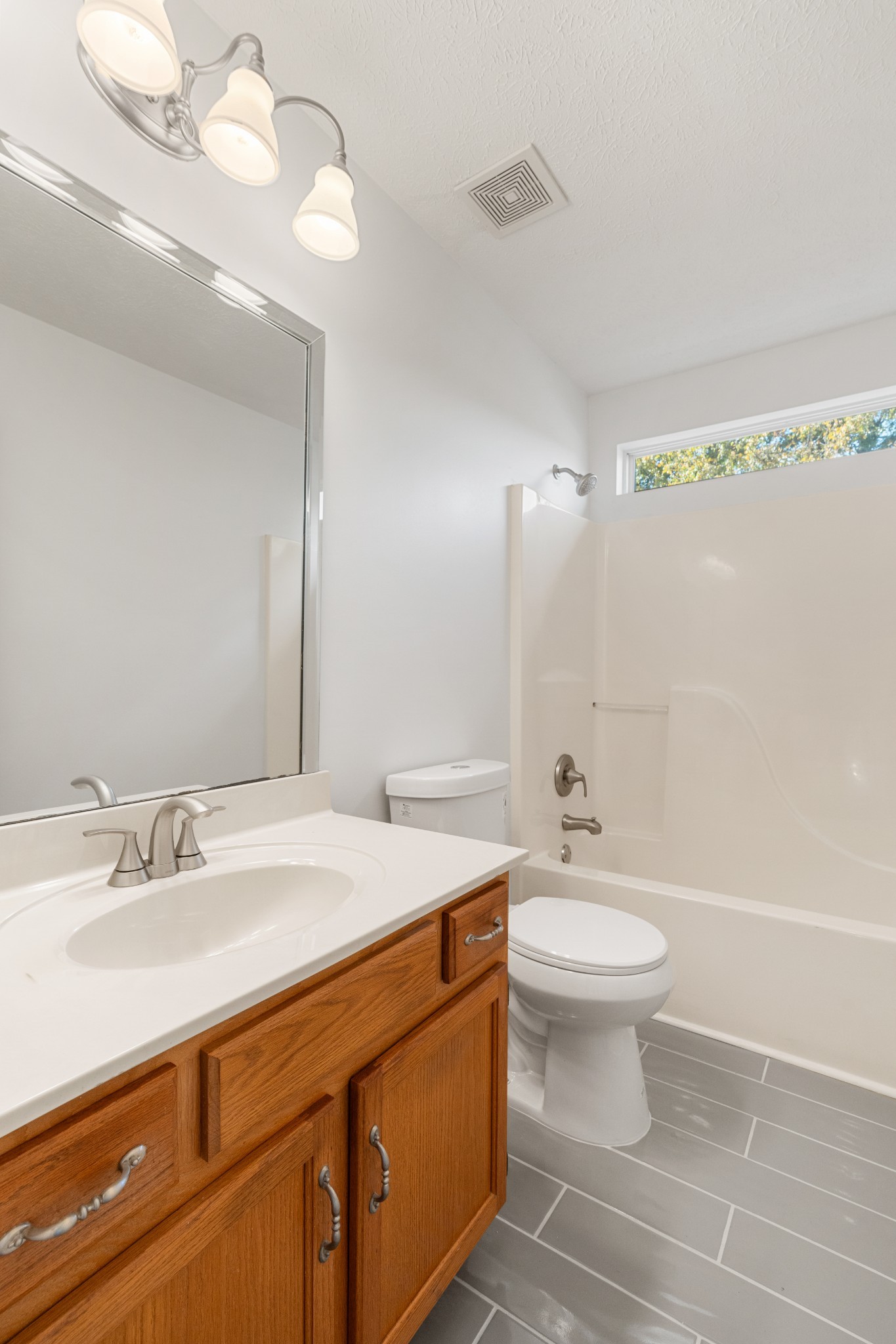 1068 Tulip Grove Road Hermitage, TN 37076 - Photo 64 of 100 a bathroom with a sink a toilet a mirror and shower