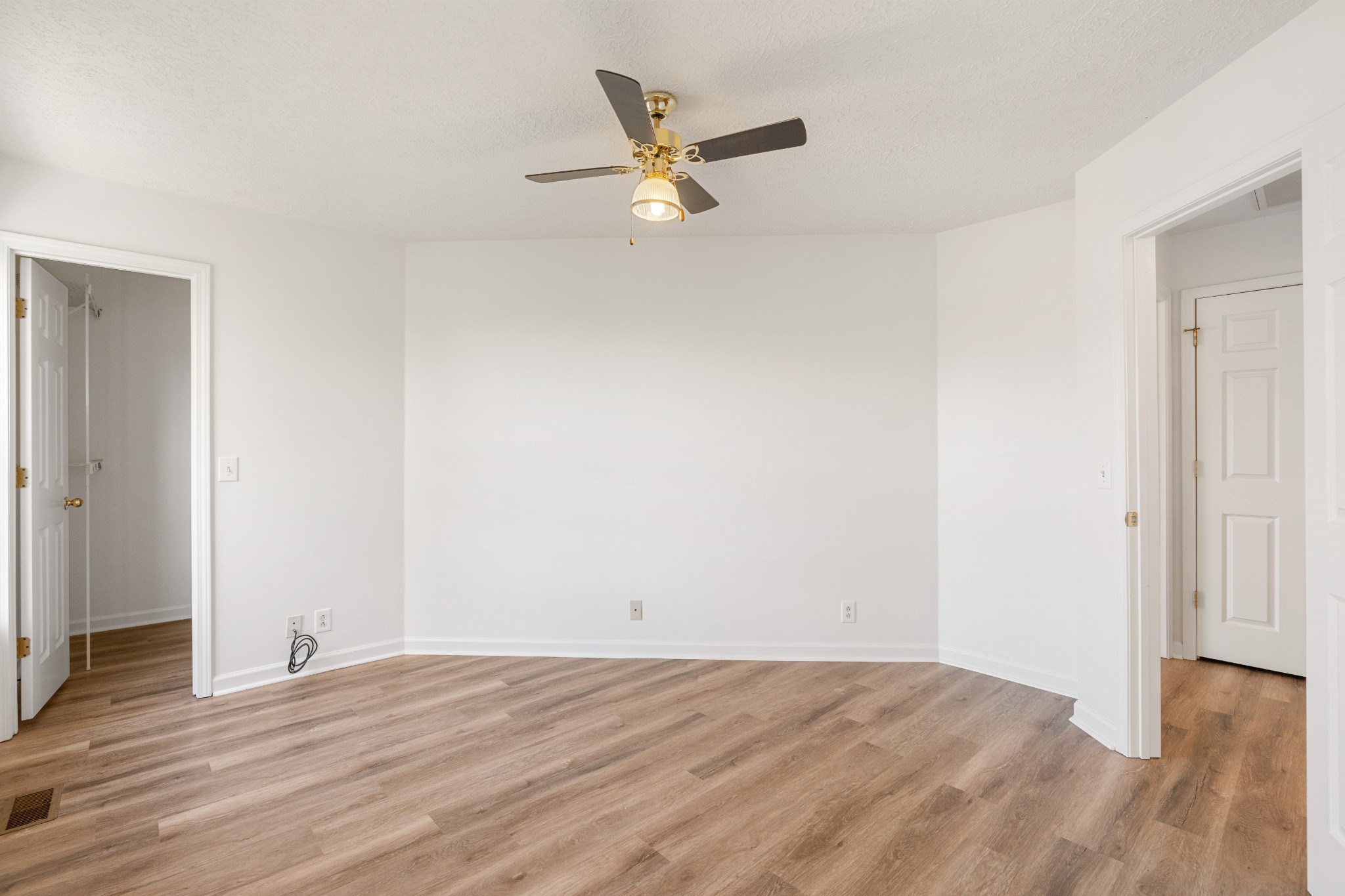 1068 Tulip Grove Road Hermitage, TN 37076 - Photo 94 of 100 an empty room with wooden floor and a ceiling fan
