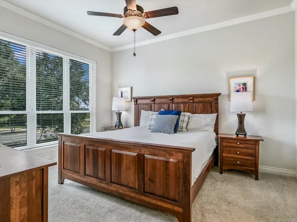 a bedroom with a bed dresser and a window
