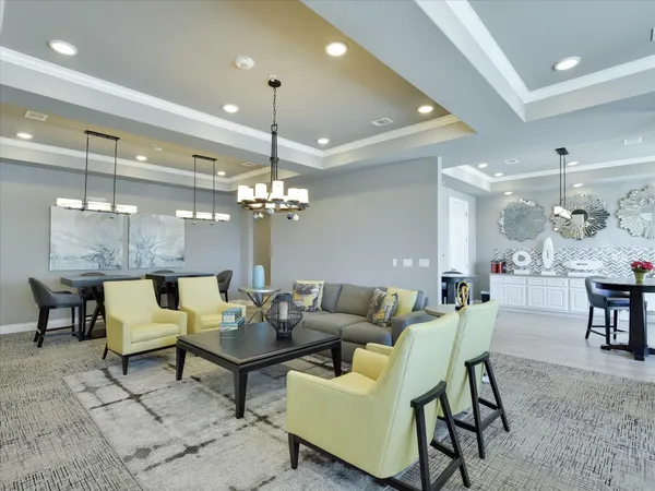 a living room with furniture a chandelier and a table