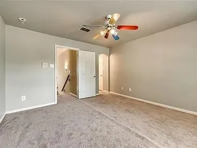 a view of a hallway with wooden floor and entryway
