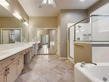 a large bathroom with a granite countertop sink mirror and shower