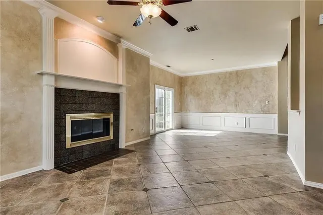 a view of an empty room with a fireplace and a window