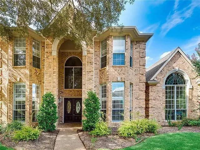 front view of a house with a garden