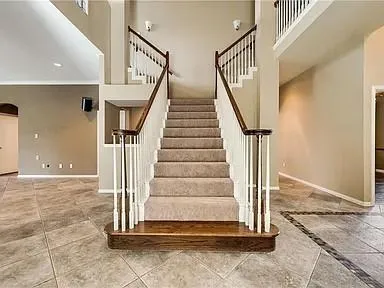 an empty room with windows and ceiling fan