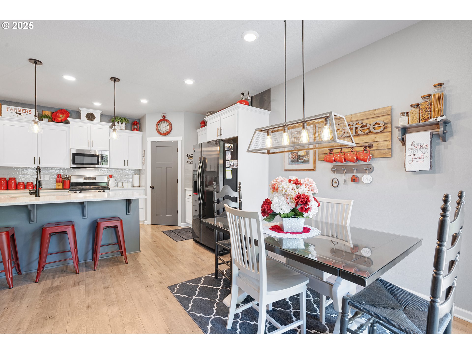 2091 35th Avenue Forest Grove, OR 97116 - Photo 13 of 43 a kitchen with stainless steel appliances kitchen island granite countertop a dining table chairs and a refrigerator