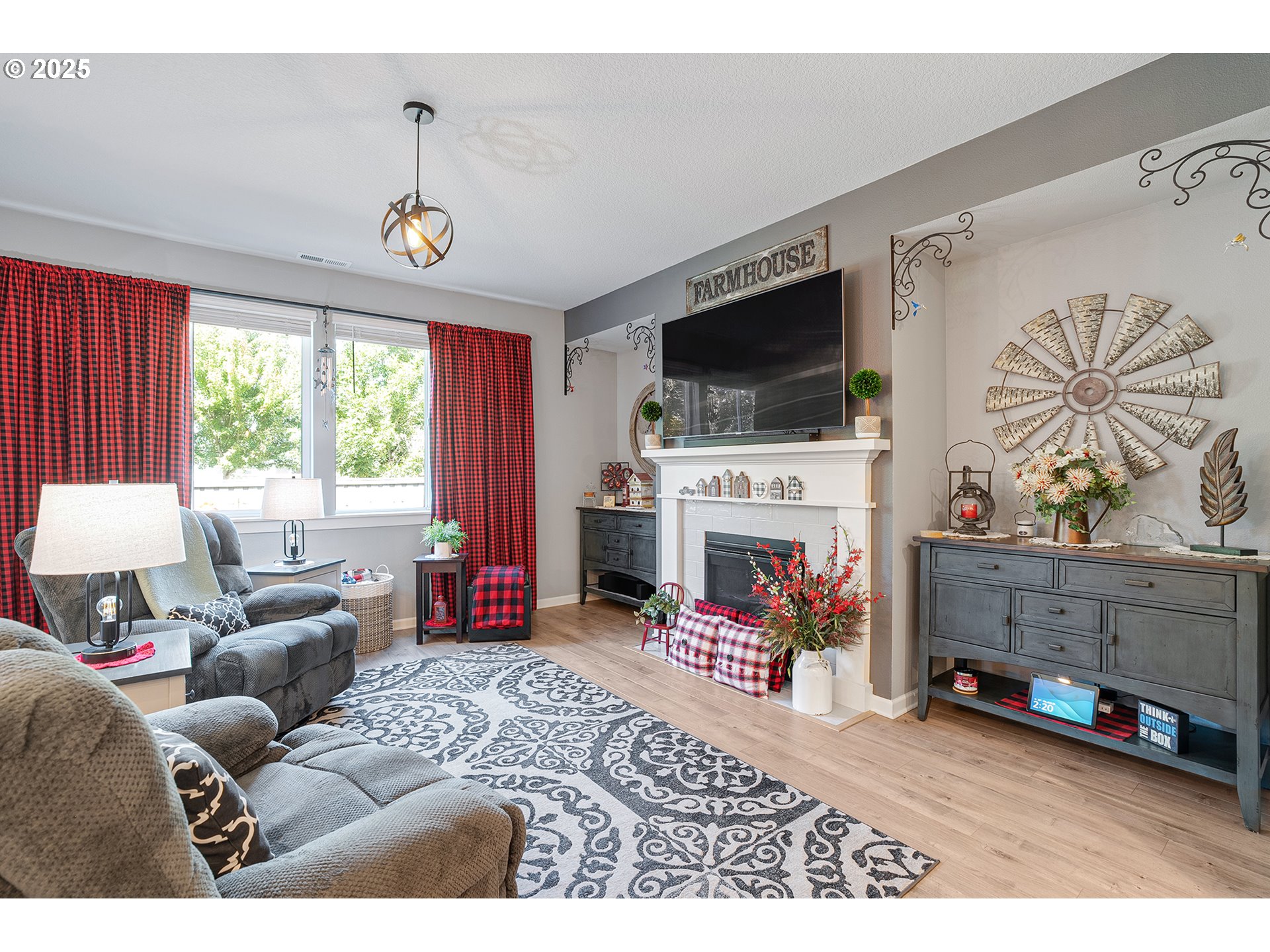 2091 35th Avenue Forest Grove, OR 97116 - Photo 14 of 43 a living room with furniture a fireplace and a flat screen tv