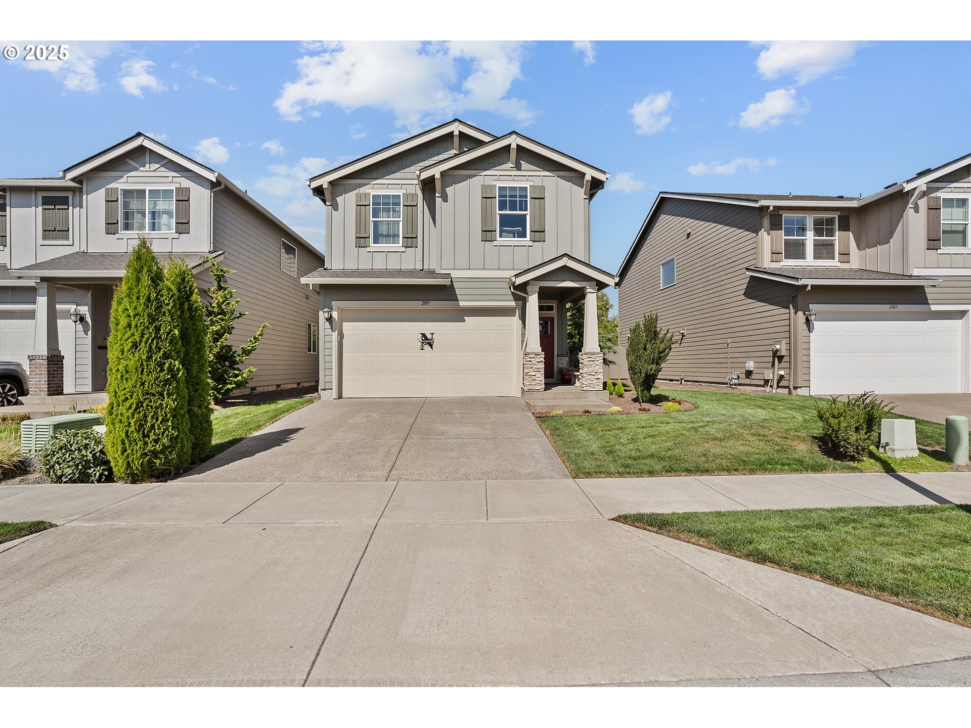 2091 35th Avenue Forest Grove, OR 97116 - Photo 42 of 43 a front view of a house with a yard and garage