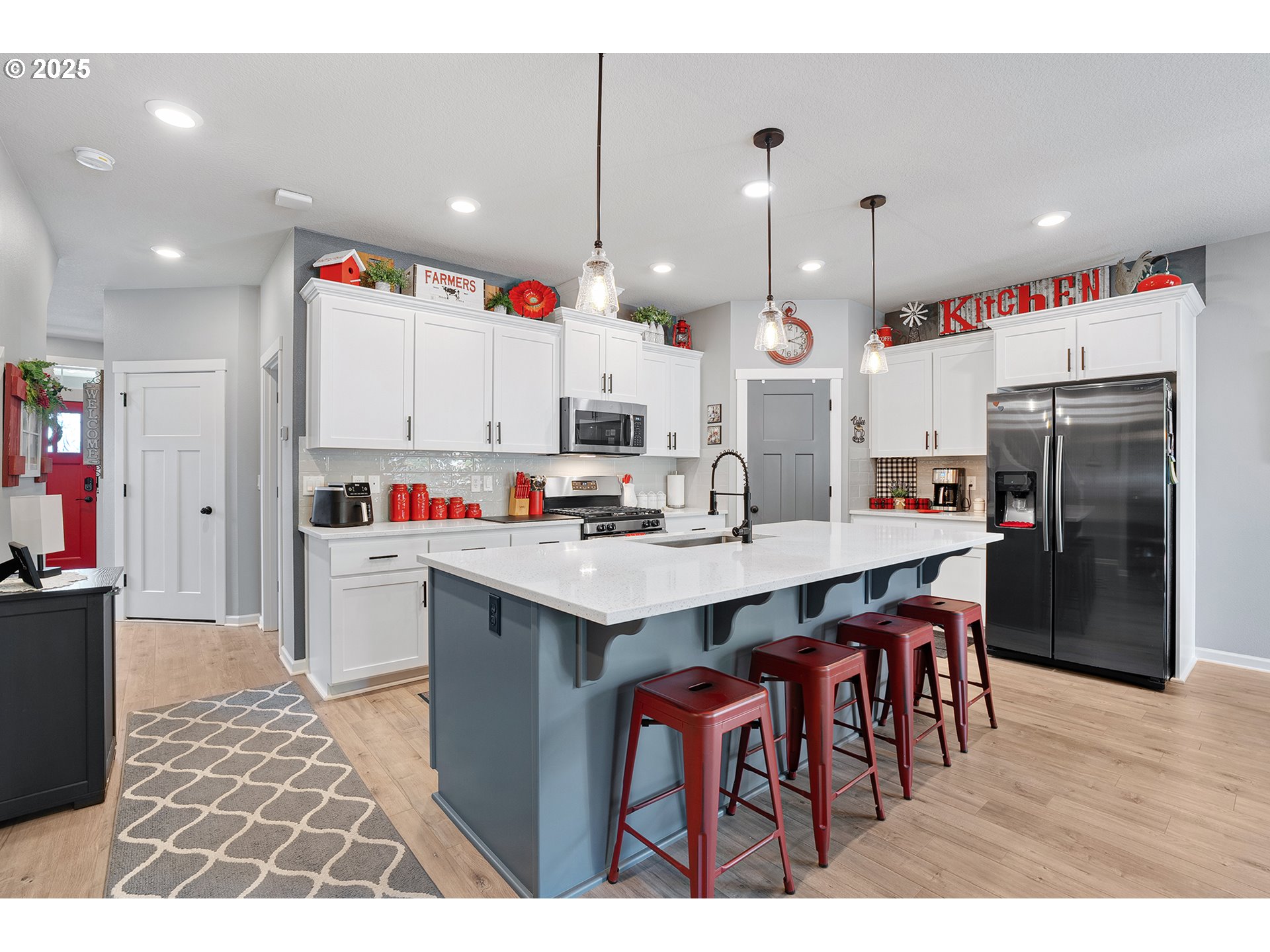 2091 35th Avenue Forest Grove, OR 97116 - Photo 6 of 43 a large kitchen with kitchen island a sink a center island and a refrigerator