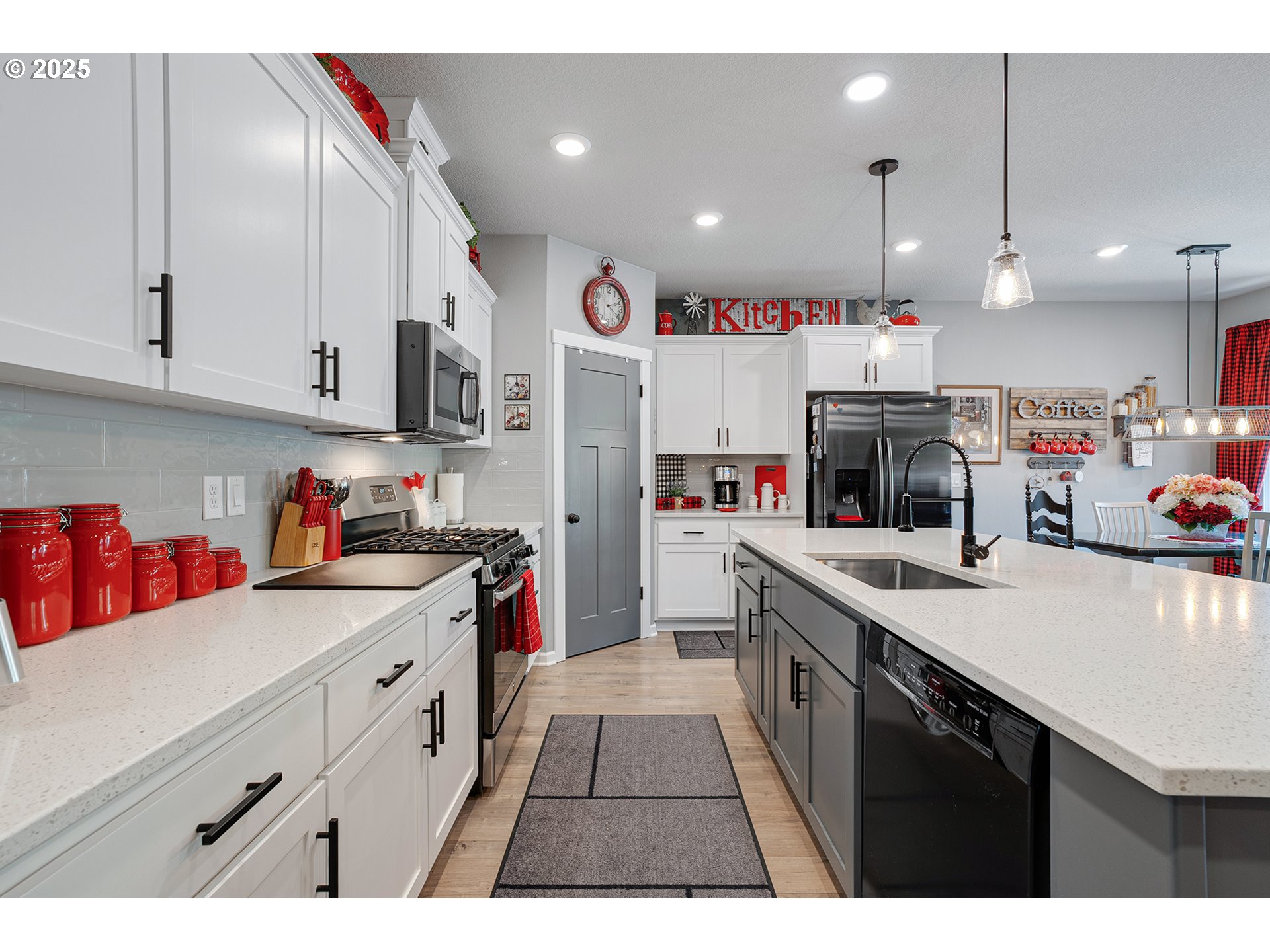 2091 35th Avenue Forest Grove, OR 97116 - Photo 10 of 43 a kitchen that has a lot of cabinets in it and wooden floors