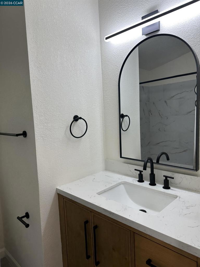 60 Wilson Way Milpitas, CA 95035 - Photo 20 of 22 a bathroom with a sink and a mirror