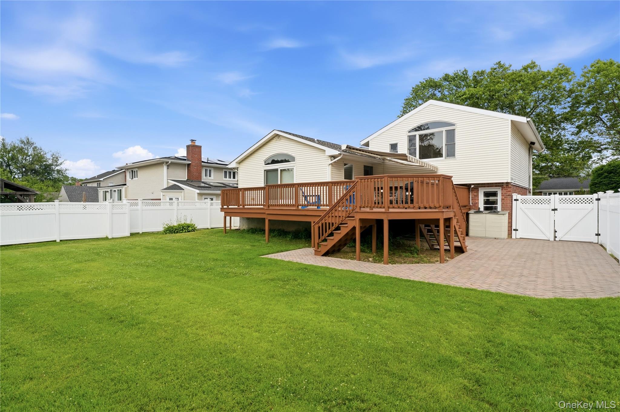 1853 Decatur Avenue Merrick, NY 11566 - Photo 35 of 43 a front view of a house with a garden and deck