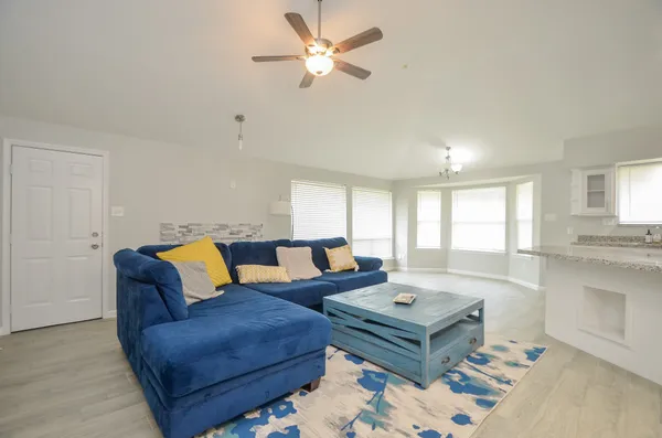 a living room with furniture and a large window