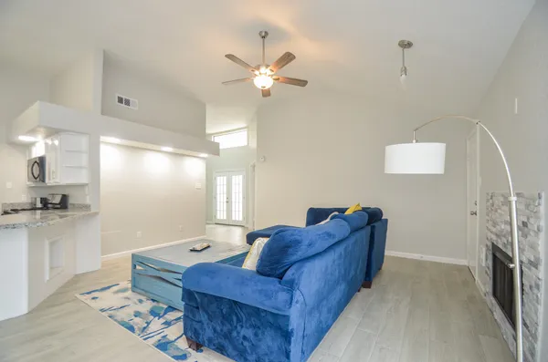 a living room with furniture and a chandelier