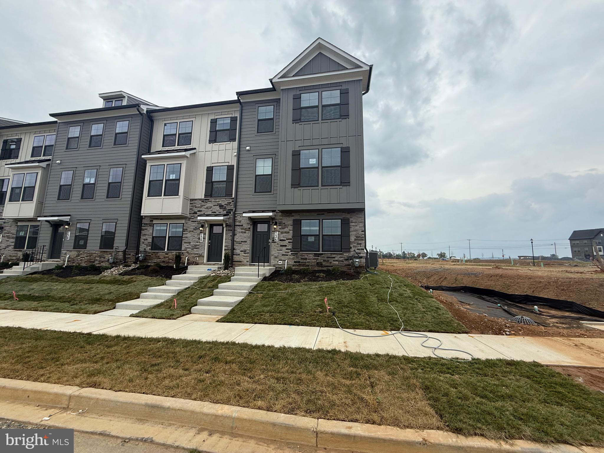 a front view of a residential apartment building with a yard