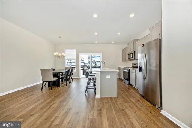 a dining room with furniture and wooden floor