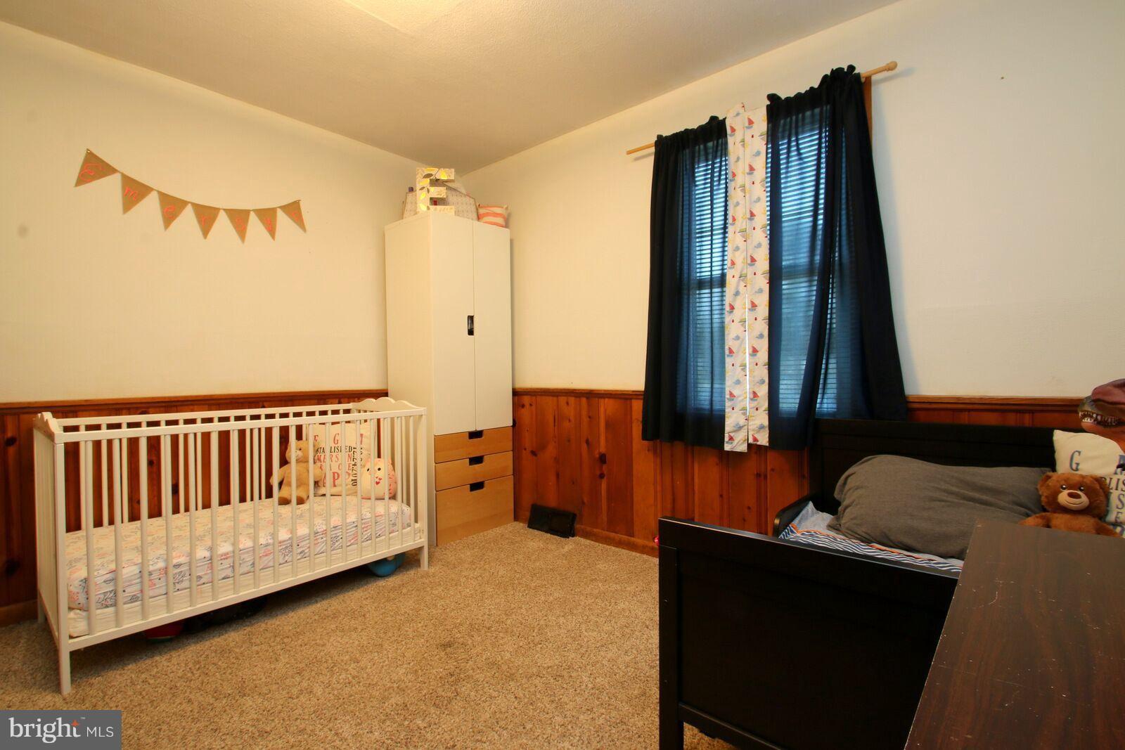 957 Martin Road Baltimore, MD 21221 - Photo 14 of 30 a bedroom with a bed and wooden floor