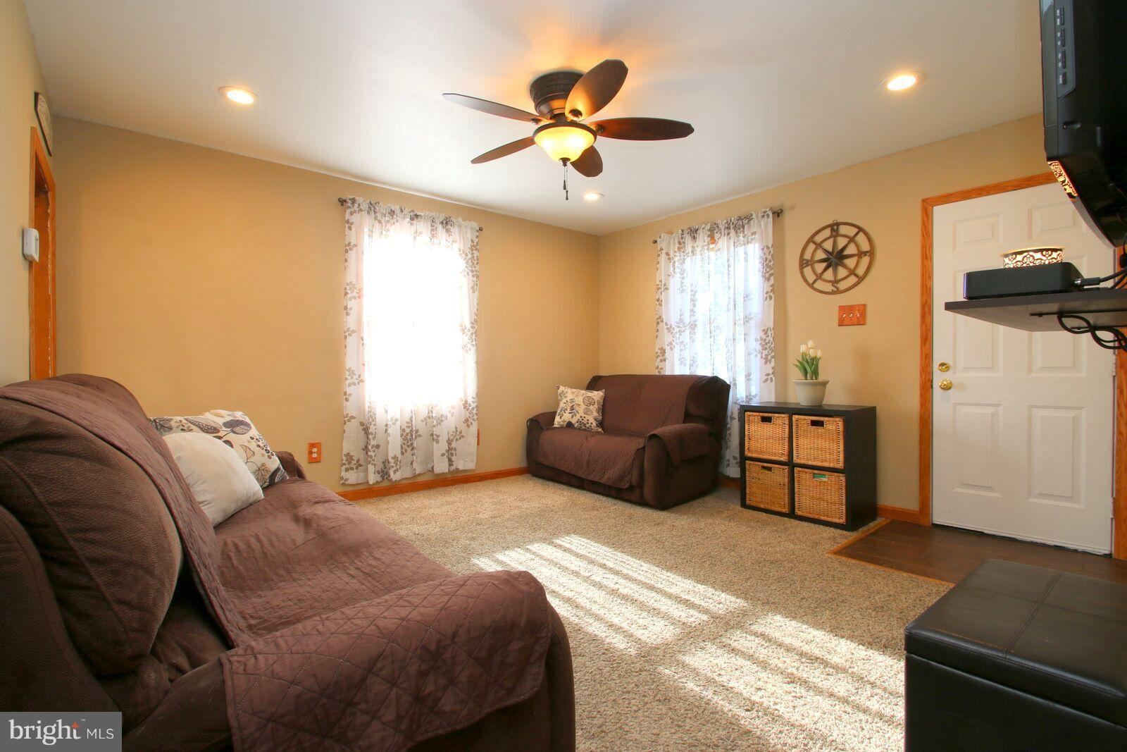 957 Martin Road Baltimore, MD 21221 - Photo 5 of 30 a spacious bedroom with a bed and a chandelier