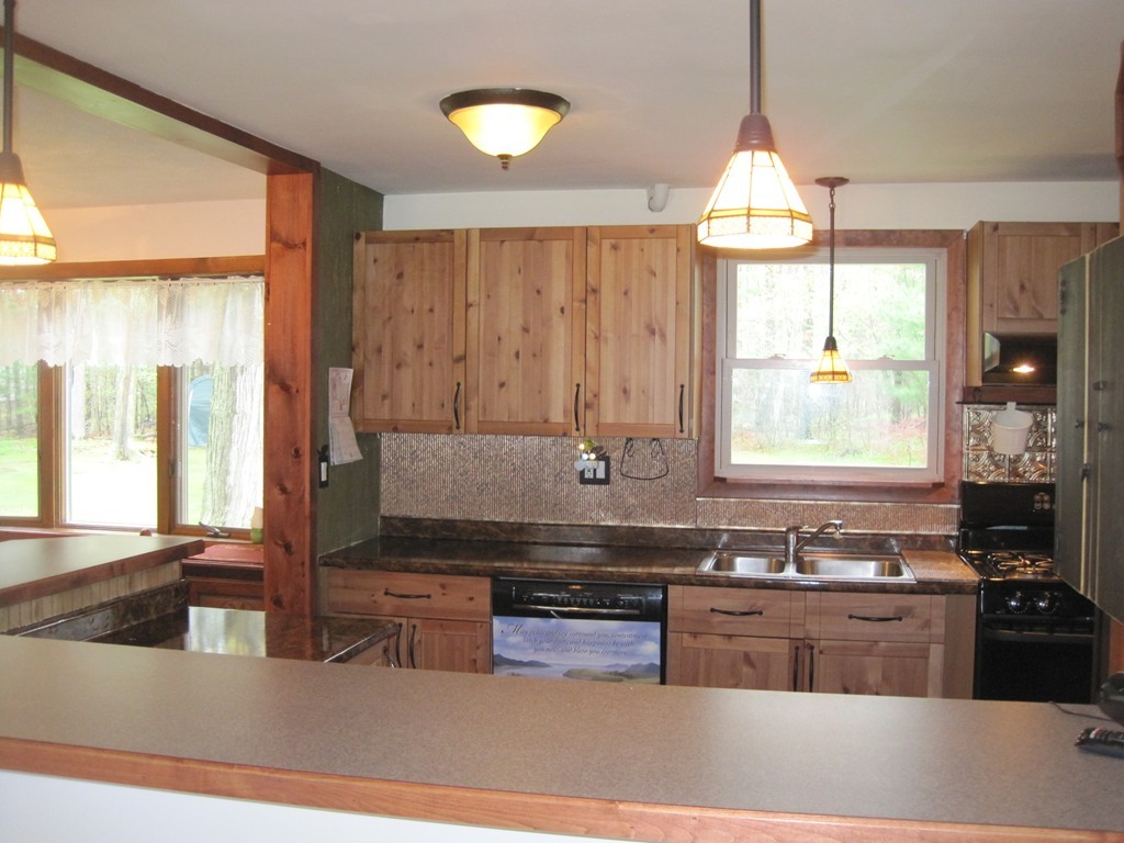15 Kimbrough Road Billerica, MA 01821 - Photo 2 of 15 a kitchen with stainless steel appliances granite countertop a stove a sink and a granite counter tops with a large window