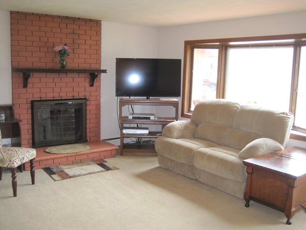 15 Kimbrough Road Billerica, MA 01821 - Photo 6 of 15 a living room with furniture and a fireplace