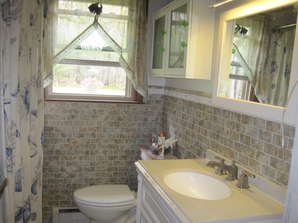 15 Kimbrough Road Billerica, MA 01821 - Photo 8 of 15 a bathroom with a sink a toilet and a shower